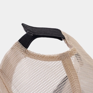 Detailed close-up of breathable mesh fabric and adjustable velcro strap on the trucker cap