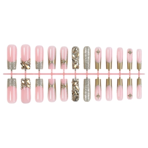 French tip press-on nails in pink and gold with luxury rhinestones and star charms