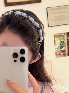 Detail of light blue bow headband with sparkling rhinestones worn in a casual setting