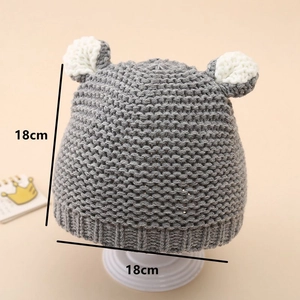 Detail of grey baby beanie with cute white ears and textured knit fabric 18x18cm size