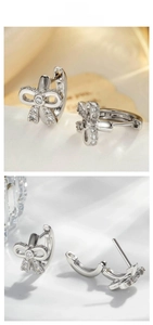 Detail view of silver bow huggie earrings with micro zircon stones and secure clasp