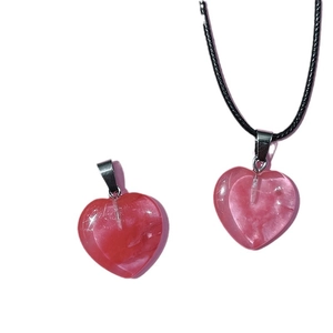 Pink heart crystal pendant with black rope necklace set on white background