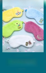Detail view of five plush faux rabbit fur sleep masks with cute cartoon embroidery