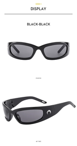 Detail of Y2K futuristic black sunglasses featuring a distinctive silver moon temple logo