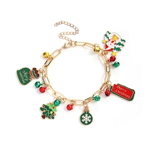 Detailed shot of Christmas charm bracelet featuring snowman, bell and tree pendants