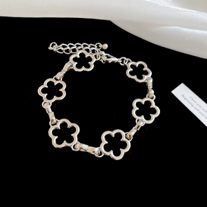 Close-up of silver hollow flower bracelet with lobster clasp and extension chain