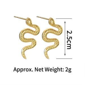 Detailed shot of golden snake stud earrings showing scale texture and 2.5cm height