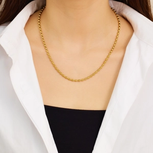 Minimalist 18K gold plated stainless steel oval bead necklace worn on a female model
