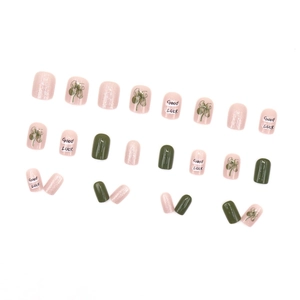 Sweet pink and green press-on nails set with glitter and lucky four-leaf clover motifs