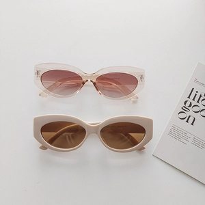 Detail view of retro round sunglasses in beige and translucent pink with gradient lenses