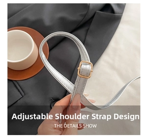 Detail showing the adjustable faux leather shoulder strap with a gold metal buckle