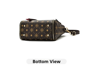 Detailed bottom view of Boston handbag showing golden protective metal feet and monogram texture