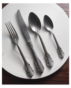 Detailed close-up of vintage embossed handles on 304 stainless steel cutlery set