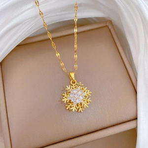 Rotating snowflake necklace with sparkling crystals on gold titanium chain for women