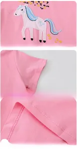 Detail of pink cotton girl dress showing unicorn embroidery, flat sleeves and hem stitching