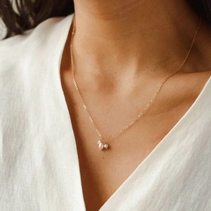 Close-up of a 14K gold plated necklace with three irregular baroque freshwater pearls