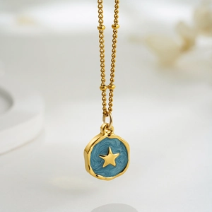 Detailed macro view of 18K gold chain with a blue enamel star pendant in high quality