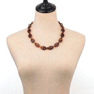 Retro acrylic leopard print necklace with oval links on a mannequin display