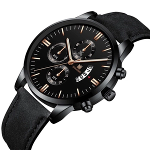 Detailed macro view of black quartz watch dial with golden hands and date window display