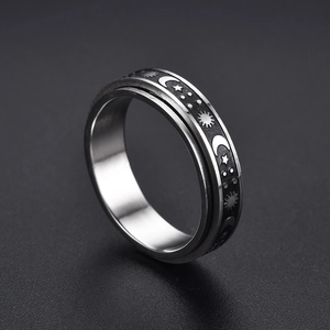 Stainless steel spinner ring with etched sun and moon patterns for stress relief