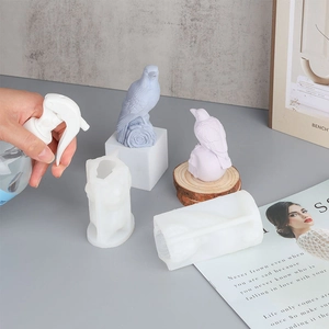 Detail of bird-shaped silicone molds for resin casting with pastel crow figurines