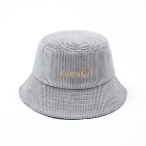 Detail showing the gray corduroy texture and yellow COCONUT embroidery on the bucket hat