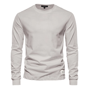 Detail of the crew neck and brand label on a light grey cotton long-sleeve T-shirt