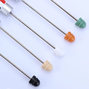 Macro view of colorful plastic heads and threaded metal pins for DIY beaded pens