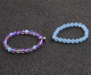 Detail of 8mm beaded couple bracelets with magnetic clasp on a dark glittery surface