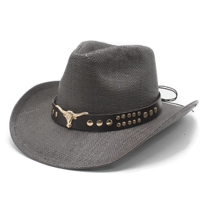 Gray woven cowboy hat with bull emblem leather band and metal studs on white background