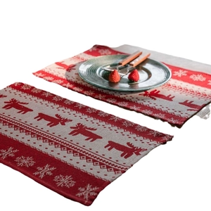 Christmas table runner featuring reindeer and snowflake patterns in red and beige weave