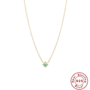 Detail of S925 sterling silver gold necklace with turquoise stone and moon pendant