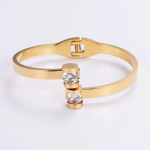 Detail of gold-plated stainless steel bangle with Roman numerals and inlaid crystal