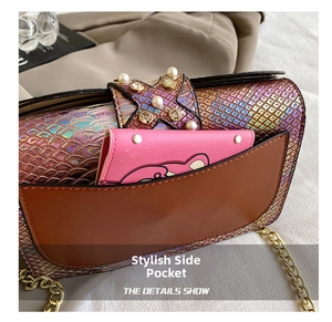 Detail of colorful snakeskin shoulder bag with pearl star decor and leather side pocket