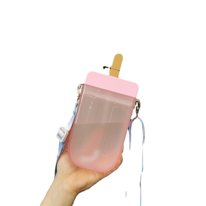 Pink popsicle shaped water bottle with colorful strap and brown lid on white background