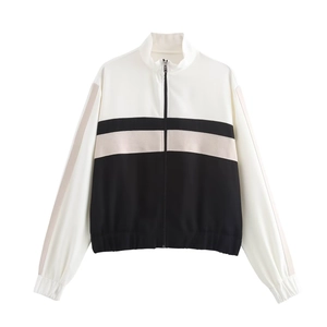 Detail view of tri-color patchwork sports jacket with stand collar and zipper closure