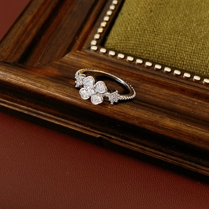 Macro detail of silver flower ring with zircons on a vintage dark wood background