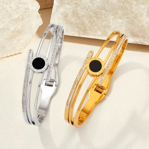 Polished stainless steel roman numeral bangles in gold and silver with crystal accents