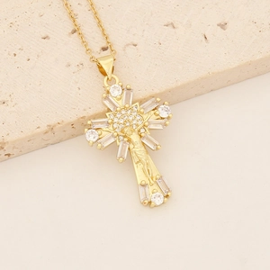 Detailed macro view of 18K gold plated cross pendant with cubic zirconia and Jesus figure