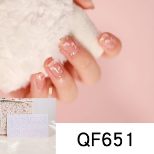 Close-up of QF651 nail stickers featuring white hearts on transparent base with pink background