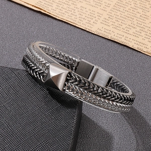 Detail of silver and black two-tone steel woven bracelet with magnetic pyramid clasp