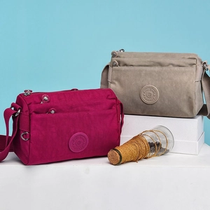 Multi-pocket nylon crossbody bags for women in burgundy and beige with adjustable straps