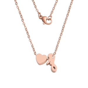 Detail of rose gold stainless steel necklace with heart and M letter charm and lobster clasp