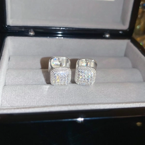 Detailed macro view of square silver hoop earrings with pave-set shimmering crystals