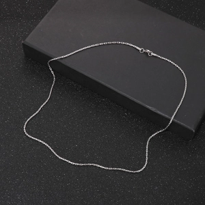 Detail view of silver stainless steel chain necklace with lobster clasp on black background
