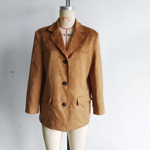 Detail of brown faux suede blazer showing notch lapels and three-button closure