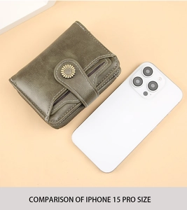 Green PU leather wallet with sunflower snap button shown next to iPhone 15 Pro for scale