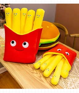 Close-up of plush french fries and burger pillows with cute cartoon smiling faces