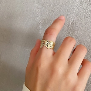 Macro detail of gold S925 sterling silver ring with irregular hammered lava texture