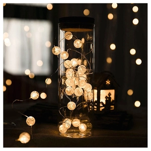Detail of warm white LED crackle glass ball lights inside a transparent glass jar